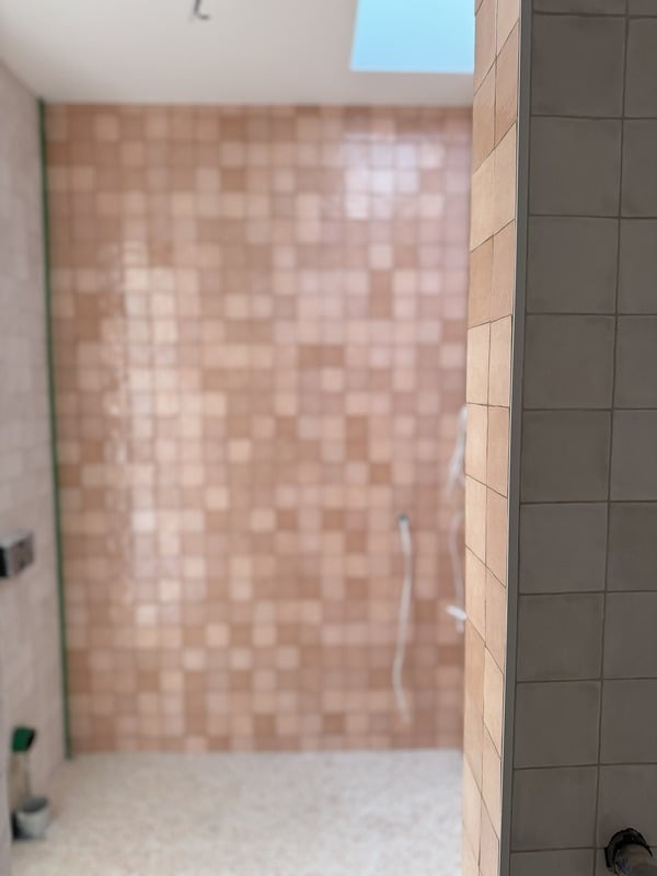 Detail of a neatly cut tile edge and clean grout join